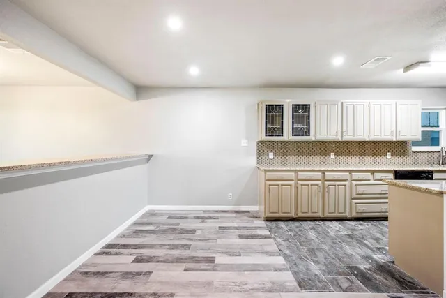 a kitchen with granite countertop white cabinets and white appliances