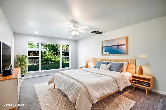 a bedroom with a large bed and a large window