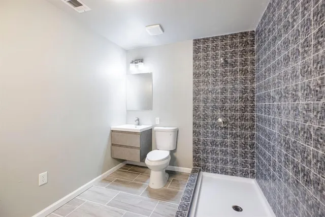a bathroom with a toilet and a shower