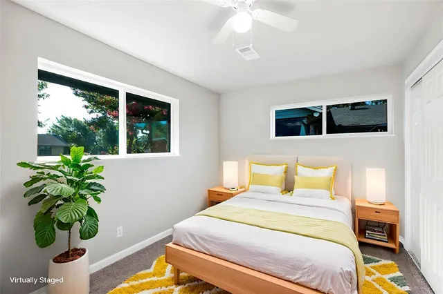 a bedroom with a bed and a potted plant
