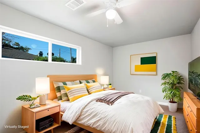 a bedroom with a bed and ceiling fan