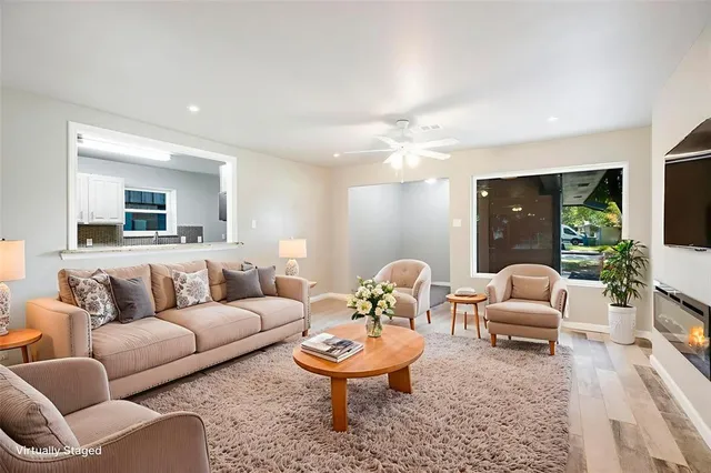 a living room with furniture and a large mirror