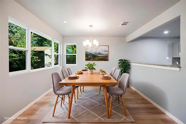 a view of a dining room with furniture window and wooden floor