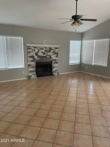 a view of an empty room with a fireplace and a window