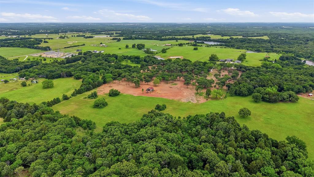 410 Arkansas Road Sadler, TX 76264 - Photo 40 of 40 Expansive property featuring a central clearing, surrounded by dense mature trees and open green spaces