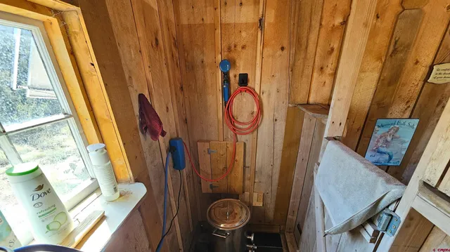 a bathroom with a sink a toilet and a window