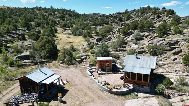 an aerial view of a house with swimming pool and outdoor seating