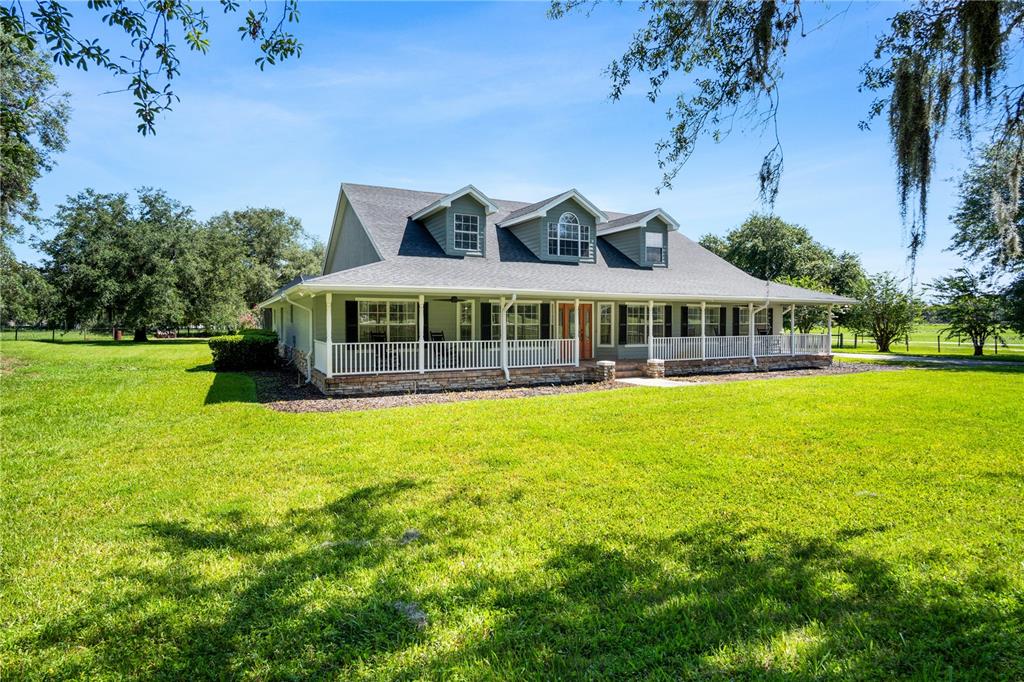 9045 Lake Hatchineha Road Kissimmee, FL 34759 - Photo 2 of 47 a view of a house with a garden and swimming pool