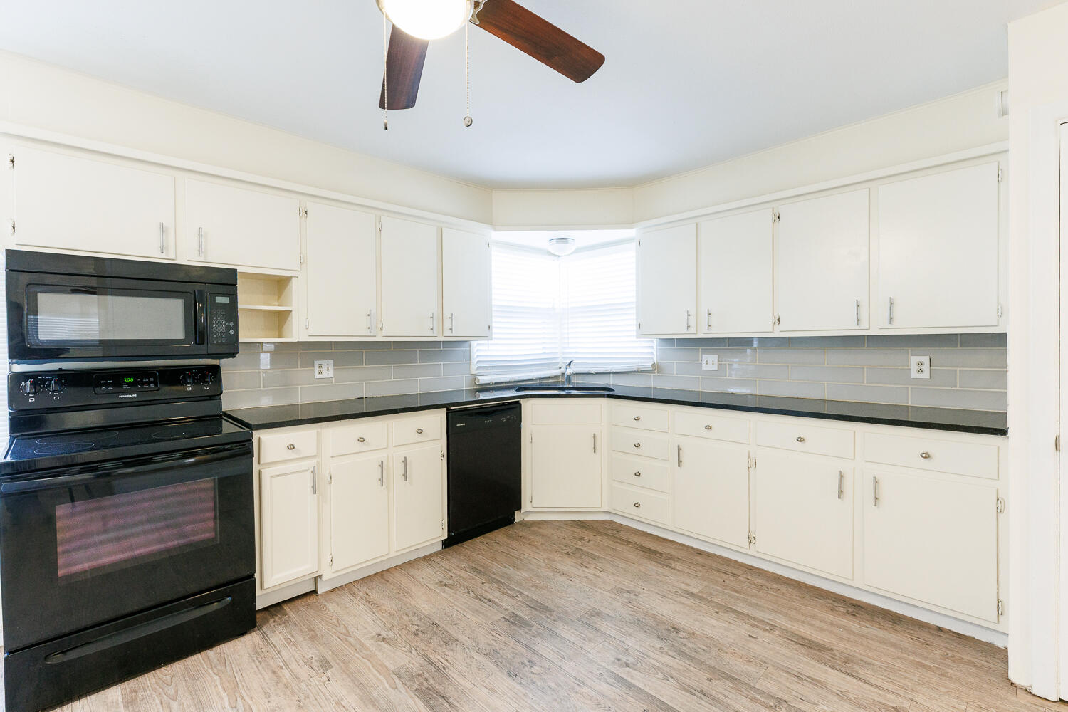 4319 40th Street Lubbock, TX 79413 - Photo 14 of 38 a kitchen with granite countertop white cabinets stainless steel appliances and a sink