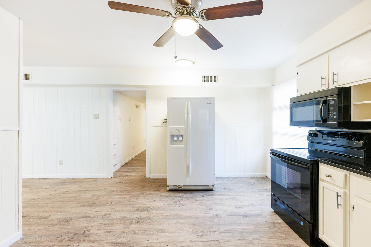 4319 40th Street Lubbock, TX 79413 - Photo 16 of 38 a kitchen with stainless steel appliances a stove microwave and a refrigerator