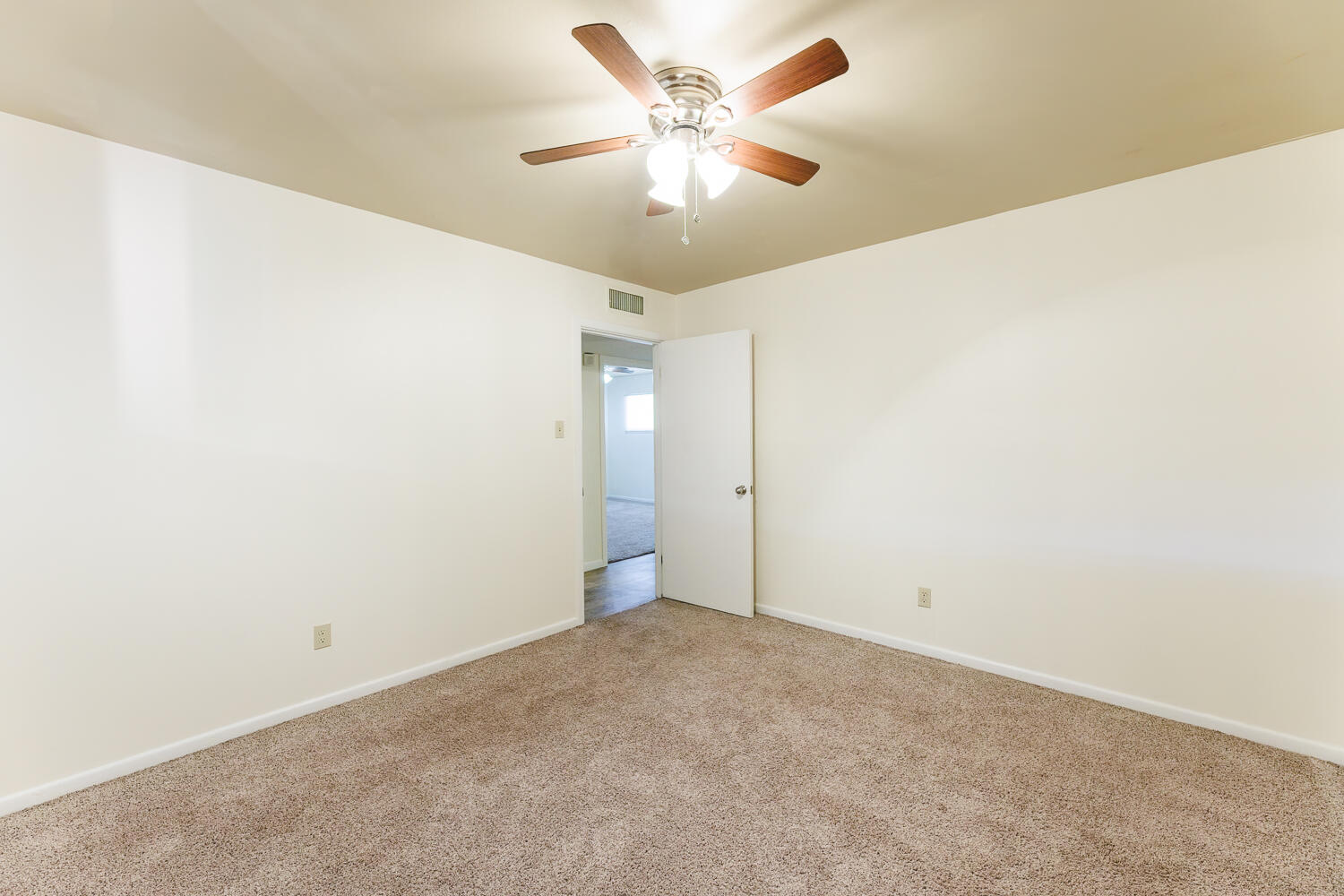 4319 40th Street Lubbock, TX 79413 - Photo 27 of 38 an empty room with a chandelier fan and a window