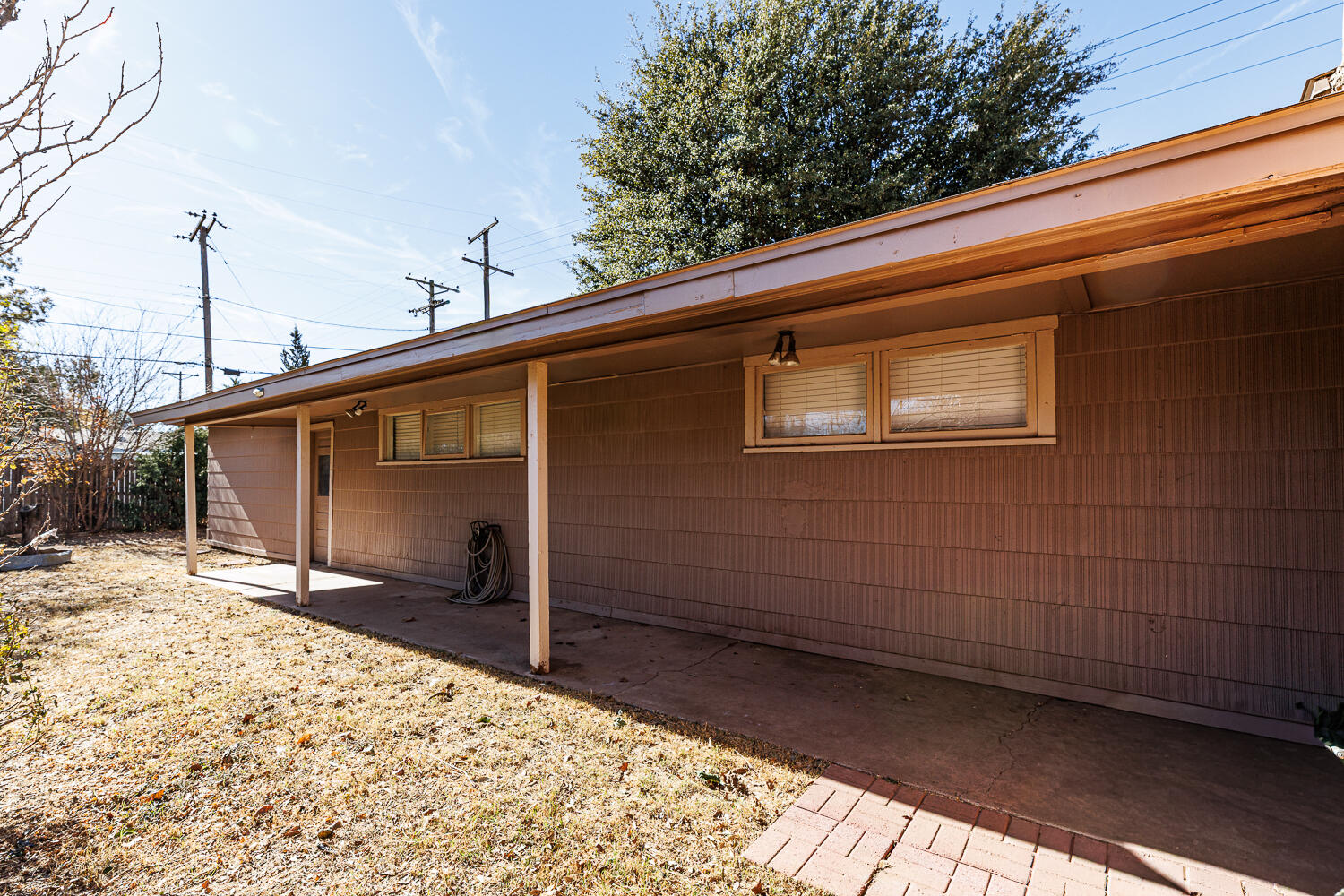 4319 40th Street Lubbock, TX 79413 - Photo 35 of 38 a backyard of a house with wooden fence and a bench