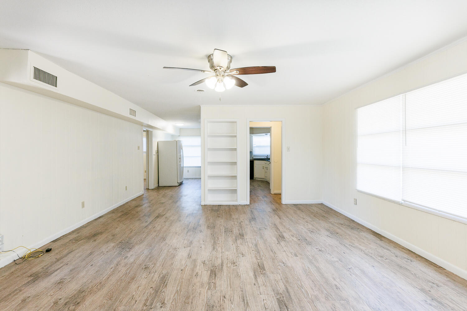 4319 40th Street Lubbock, TX 79413 - Photo 5 of 38 a view of empty room with wooden floor and fan