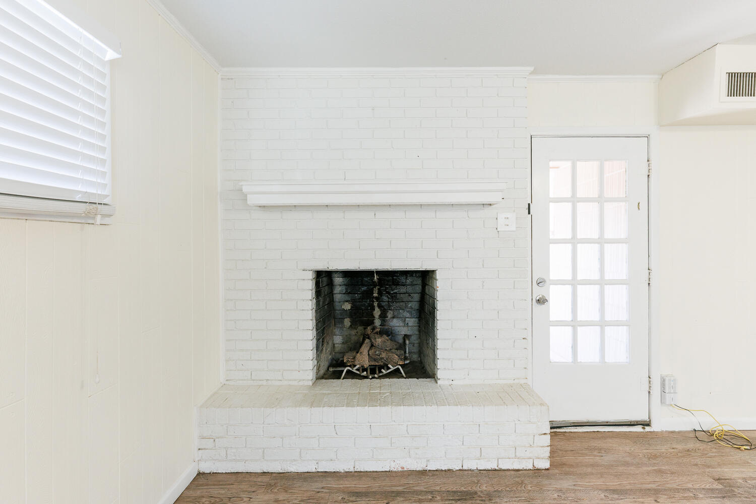 4319 40th Street Lubbock, TX 79413 - Photo 8 of 38 a living room with a fireplace and a window