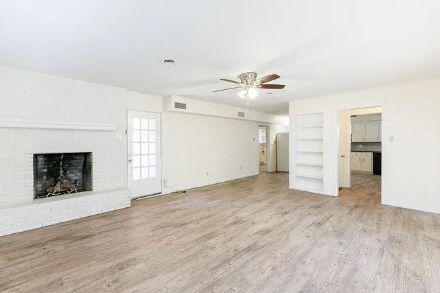 a kitchen with granite countertop a stove a sink and a microwave