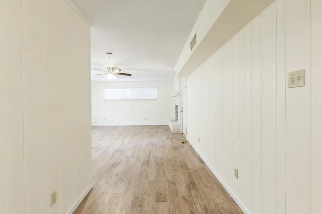 a kitchen with granite countertop white cabinets stainless steel appliances and a sink