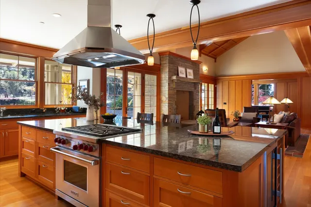 a living room filled with furniture and large windows