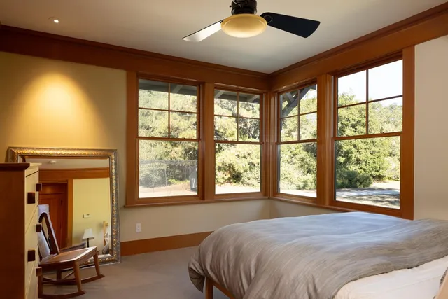 an aerial view of a residential apartment building with a yard and parking spaces