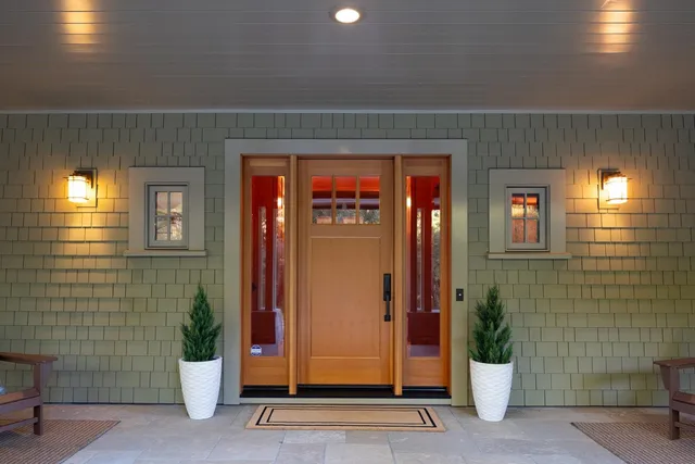 a living room with furniture a lamp and a large window