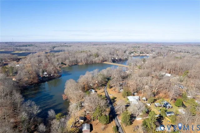 an aerial view of a house with a lake view