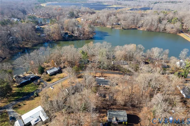 an aerial view of a house with a lake view