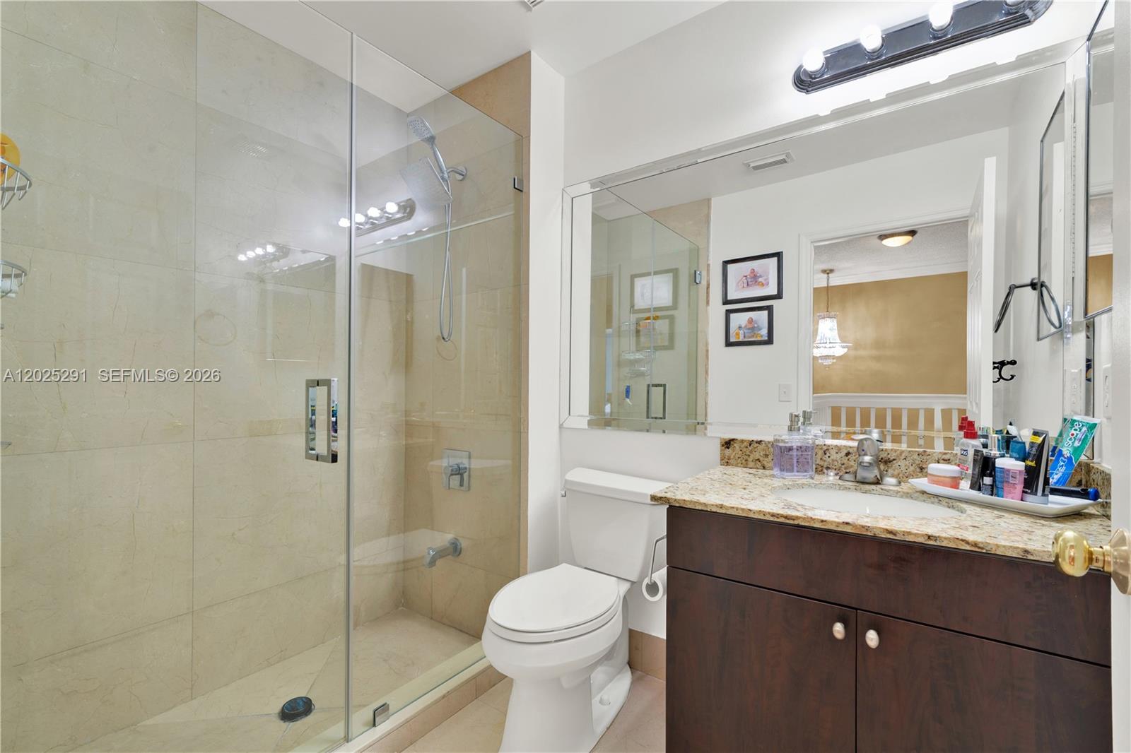 10006 Southwest 162nd Path Miami, FL 33196 - Photo 24 of 40 a bathroom with a sink a toilet and shower