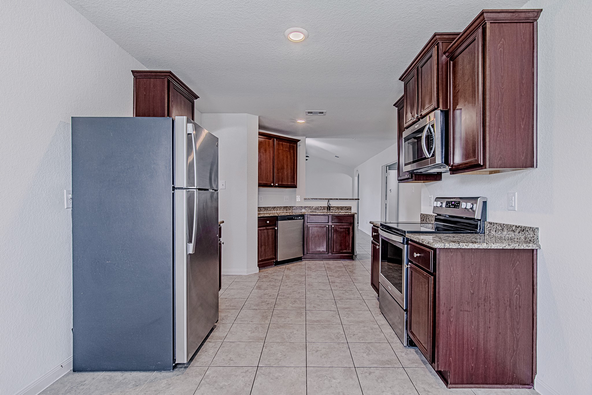 9522 Olive Stone Drive Rosharon, TX 77583 - Photo 11 of 29 a kitchen with granite countertop a stainless steel appliances cabinets and a sink