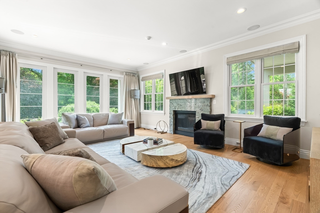 382 Lee Street Brookline, MA 02445 - Photo 20 of 38 a living room with furniture fireplace and a large window