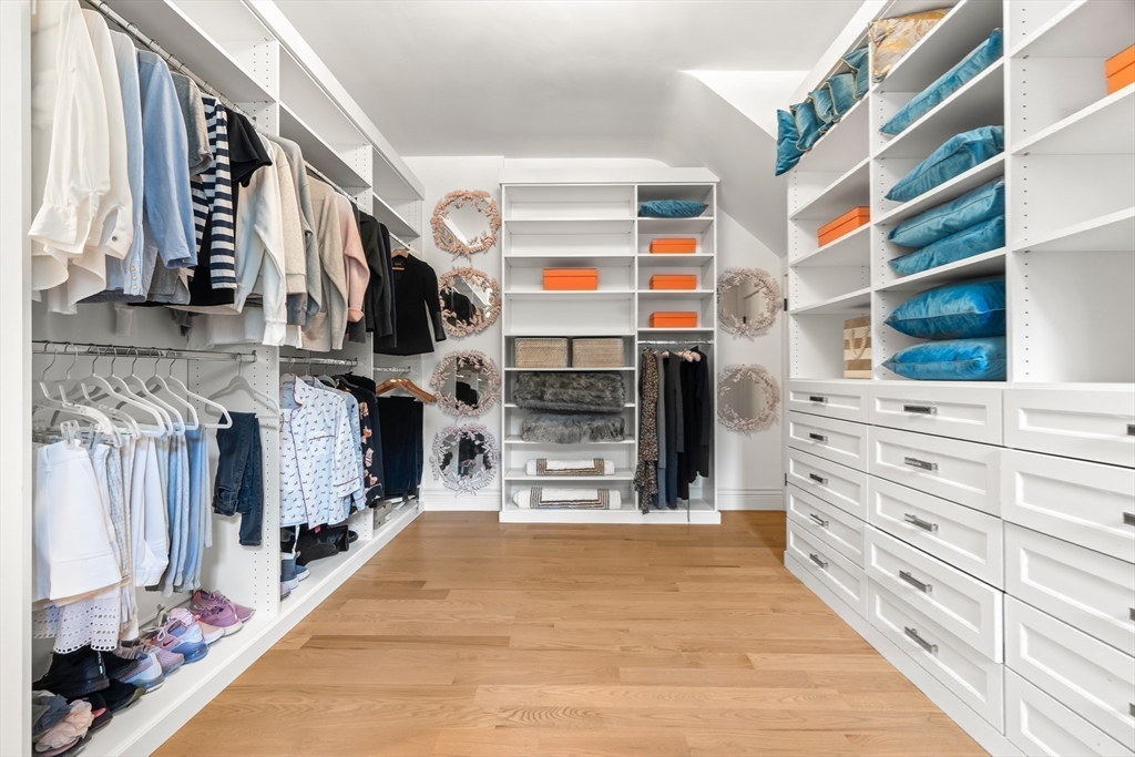 382 Lee Street Brookline, MA 02445 - Photo 28 of 38 a view of walk in closet with clothes and shoes