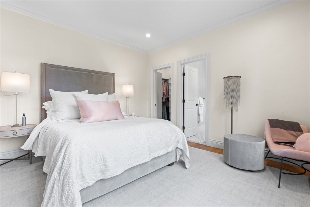 382 Lee Street Brookline, MA 02445 - Photo 33 of 38 a spacious bedroom with a bed and chair