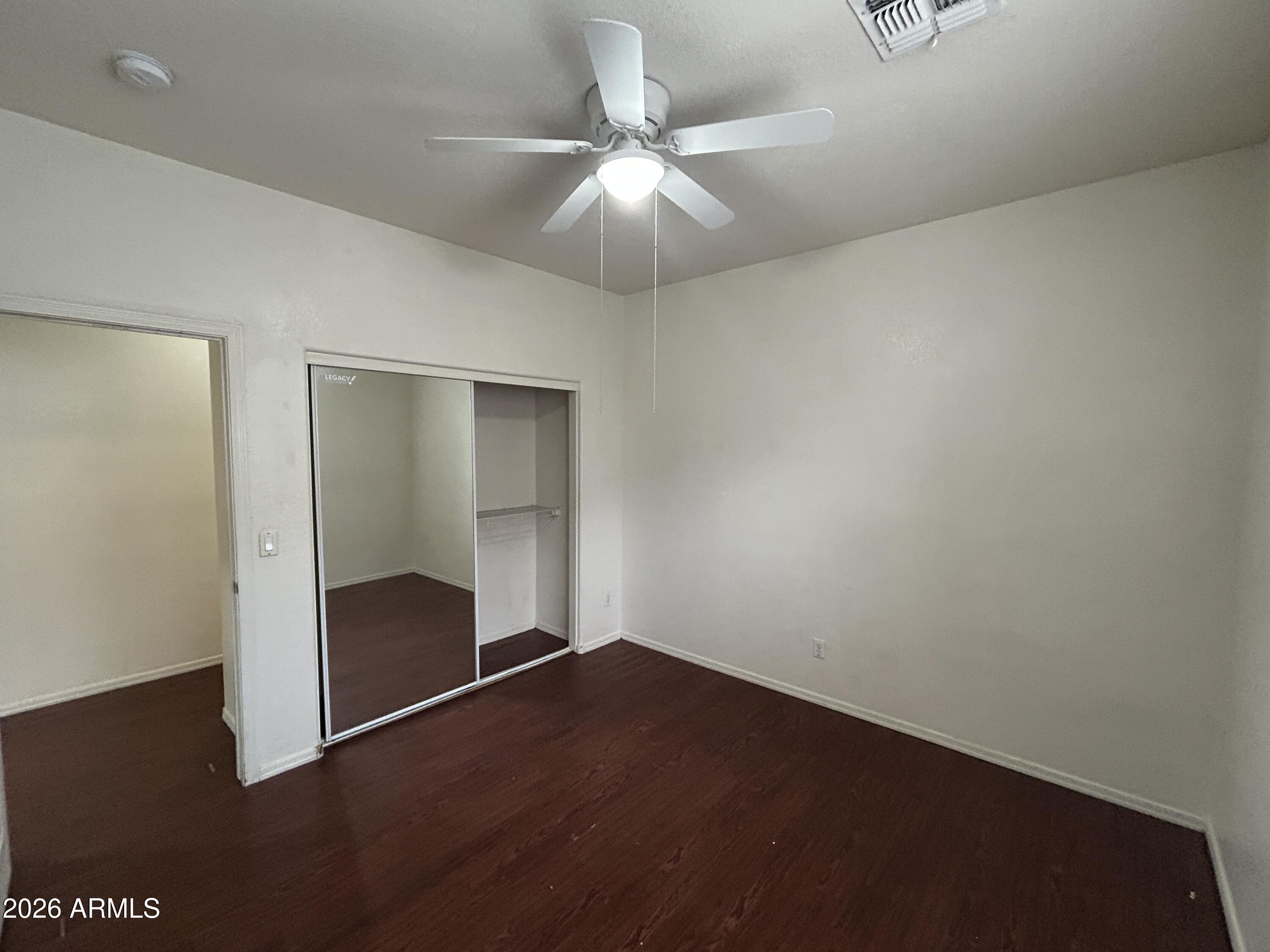 2202 West Carter Road Phoenix, AZ 85041 - Photo 11 of 20 an empty room with closet and a ceiling fan