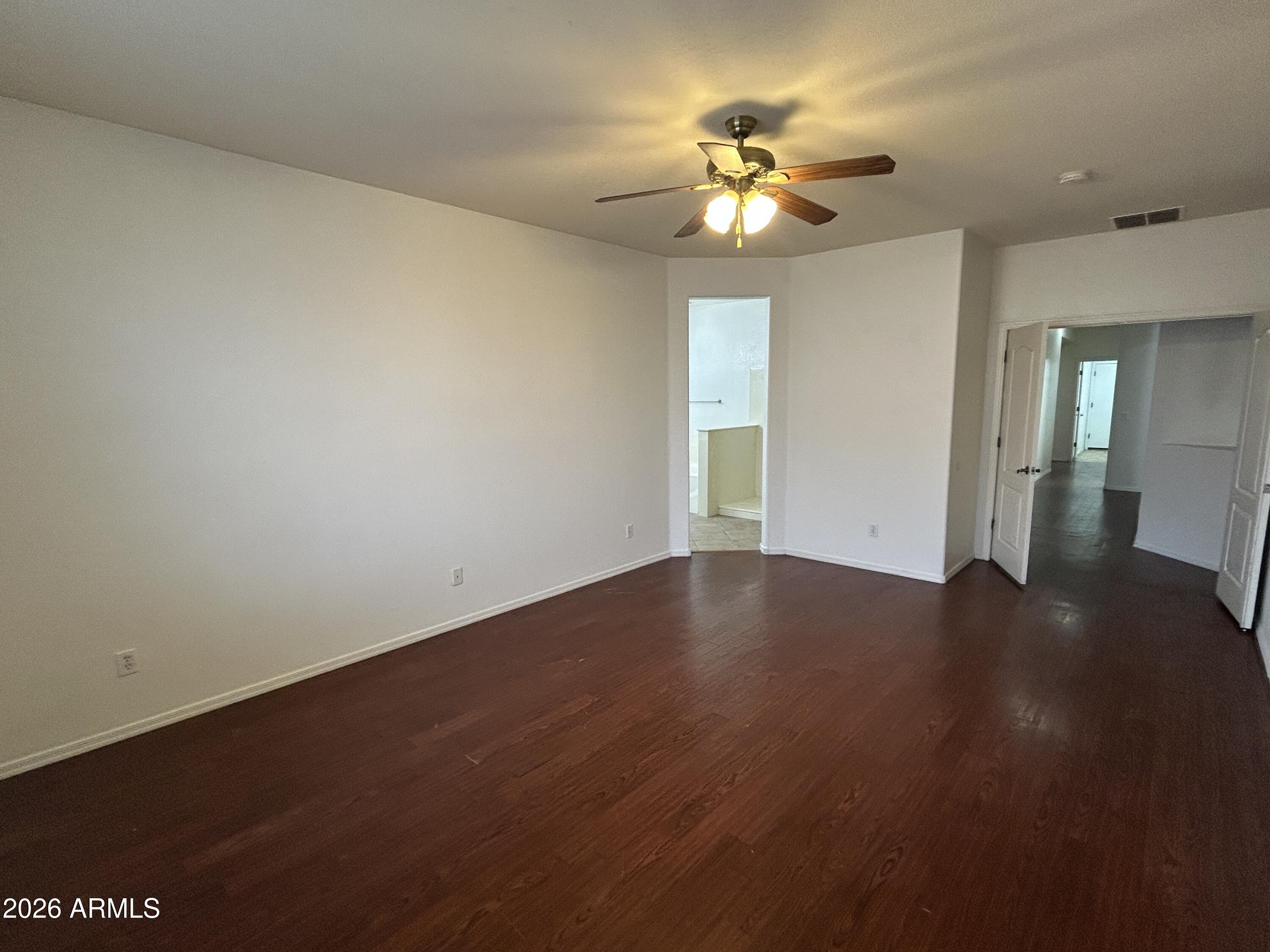 2202 West Carter Road Phoenix, AZ 85041 - Photo 15 of 20 a view of an empty room with a chandelier fan