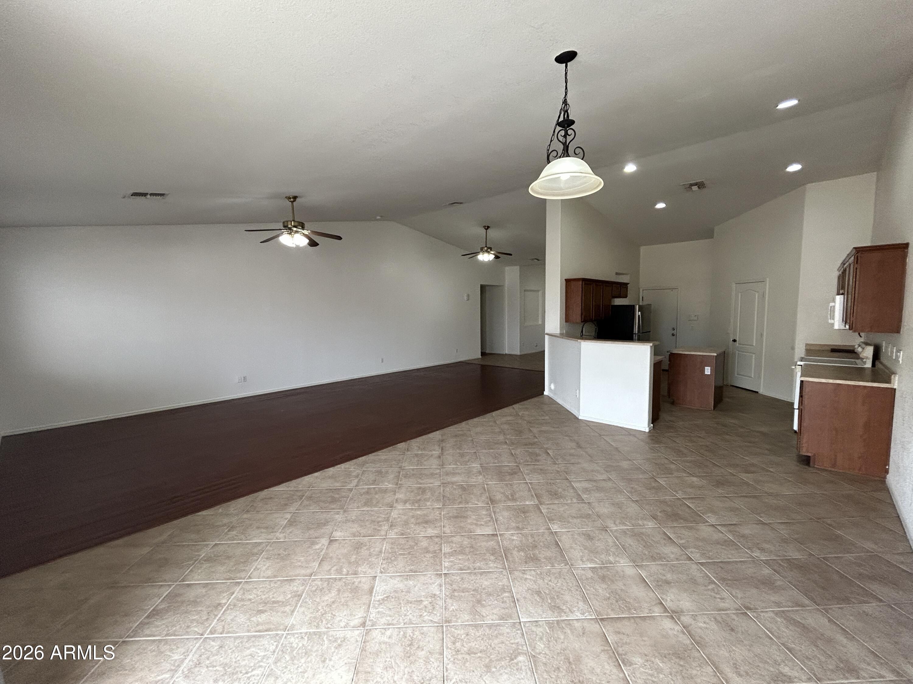 2202 West Carter Road Phoenix, AZ 85041 - Photo 4 of 20 a view of a kitchen with a stove cabinets and a floor to ceiling window
