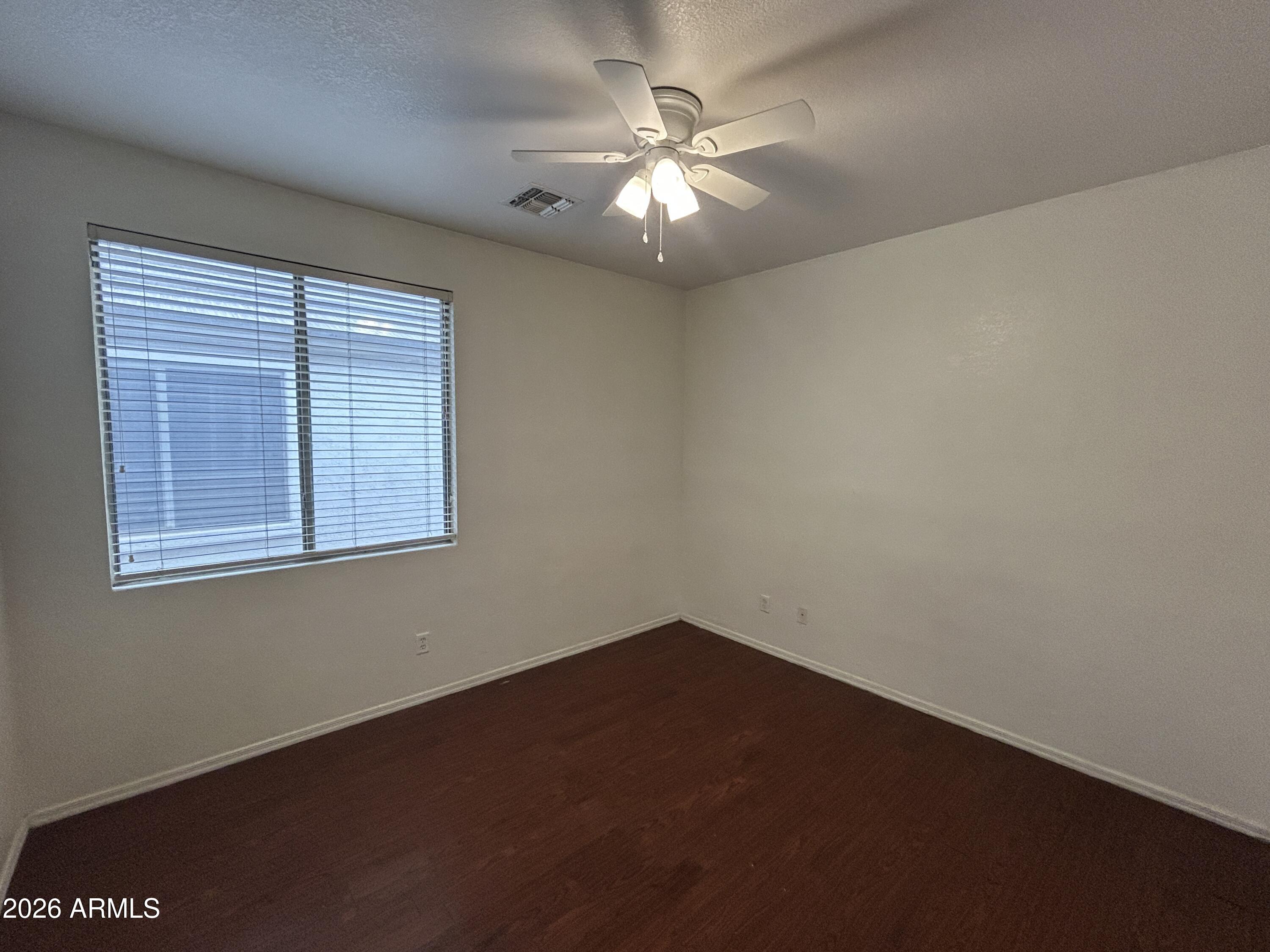 2202 West Carter Road Phoenix, AZ 85041 - Photo 8 of 20 an empty room with a window