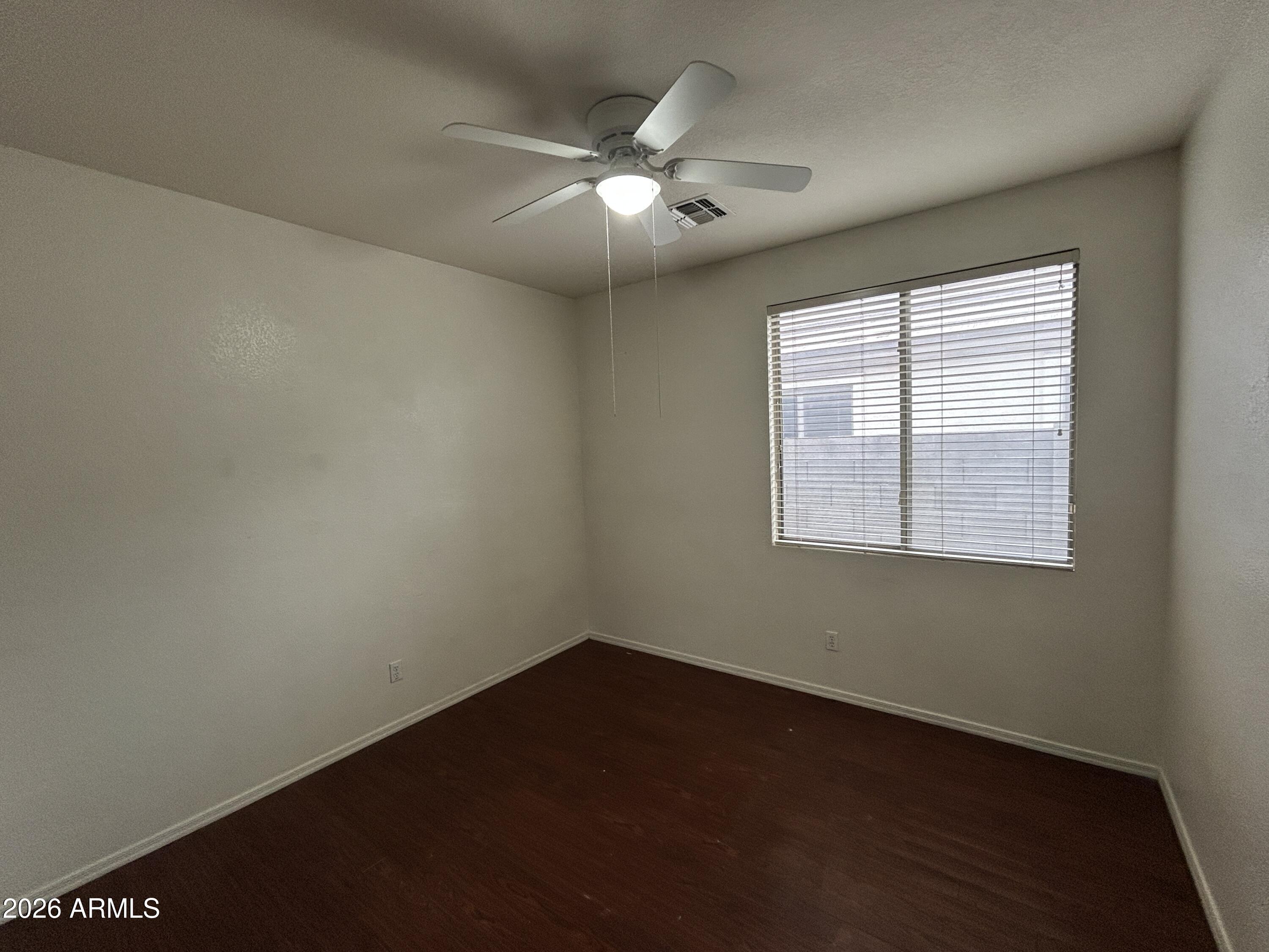 2202 West Carter Road Phoenix, AZ 85041 - Photo 10 of 20 an empty room with a window