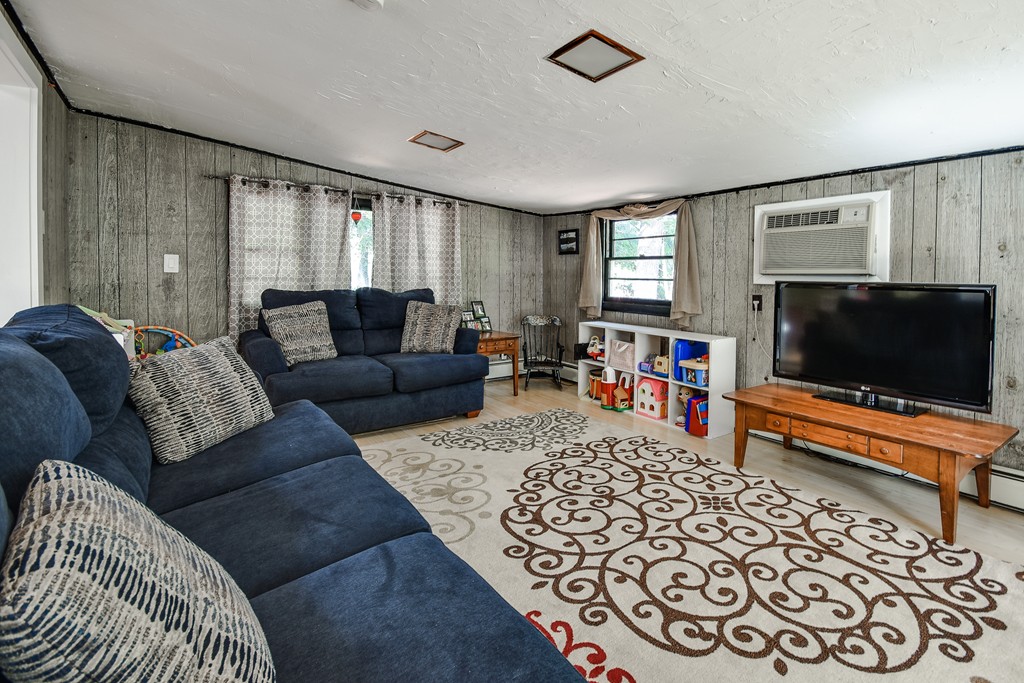9 Ruth Drive Framingham, MA 01701 - Photo 11 of 25 a living room with furniture and a flat screen tv