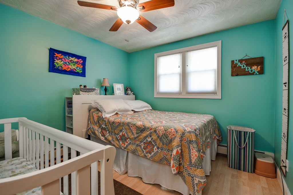 9 Ruth Drive Framingham, MA 01701 - Photo 15 of 25 a bedroom with furniture and a chandelier