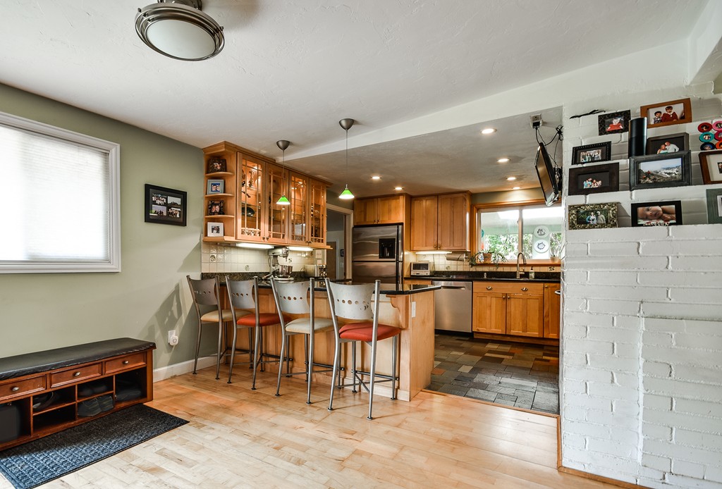 9 Ruth Drive Framingham, MA 01701 - Photo 3 of 25 a kitchen with stainless steel appliances granite countertop a refrigerator and a stove top oven