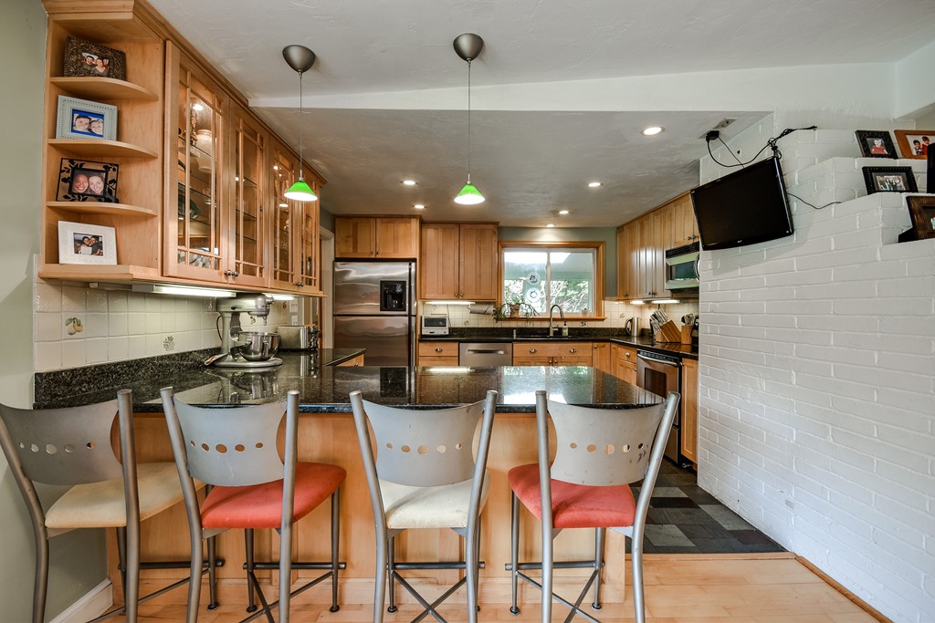 9 Ruth Drive Framingham, MA 01701 - Photo 5 of 25 a kitchen with stainless steel appliances kitchen island granite countertop a sink and cabinets