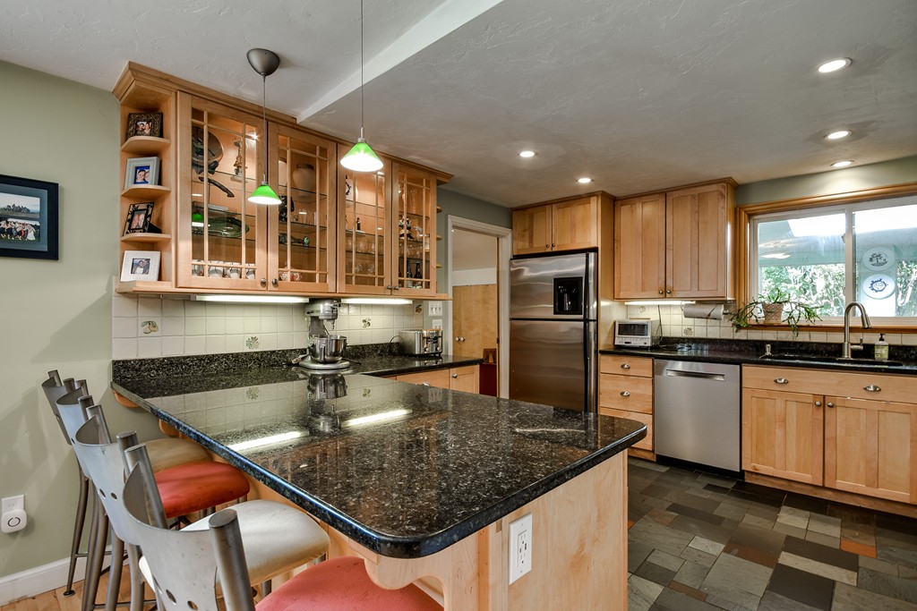 9 Ruth Drive Framingham, MA 01701 - Photo 6 of 25 a kitchen with stainless steel appliances granite countertop a sink counter space cabinets and a large window