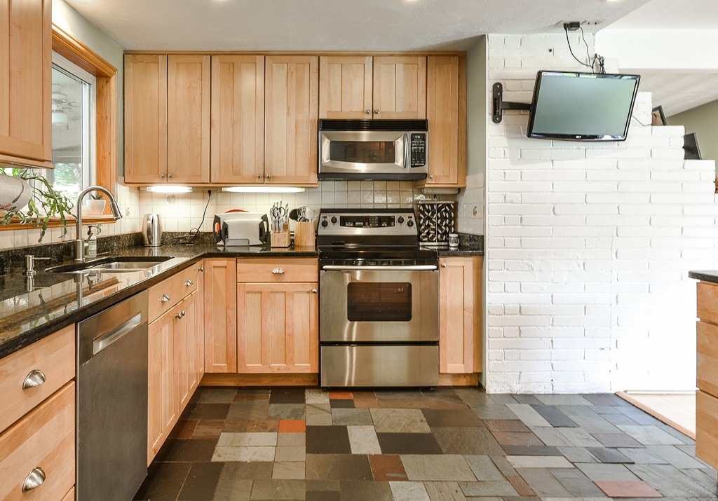 9 Ruth Drive Framingham, MA 01701 - Photo 7 of 25 a kitchen with a stove top oven sink and cabinets