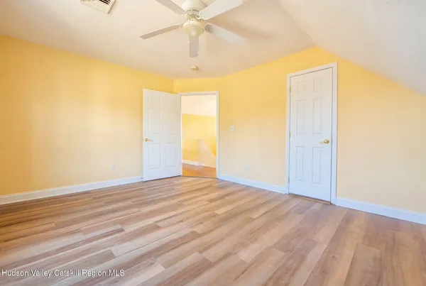 a view of a room with wooden floor and a window