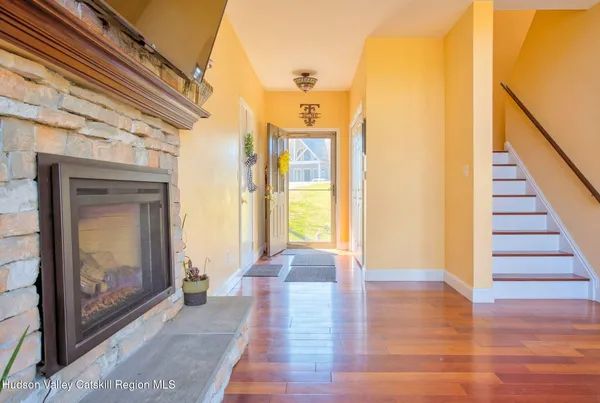 a living room with a fireplace and a flat screen tv