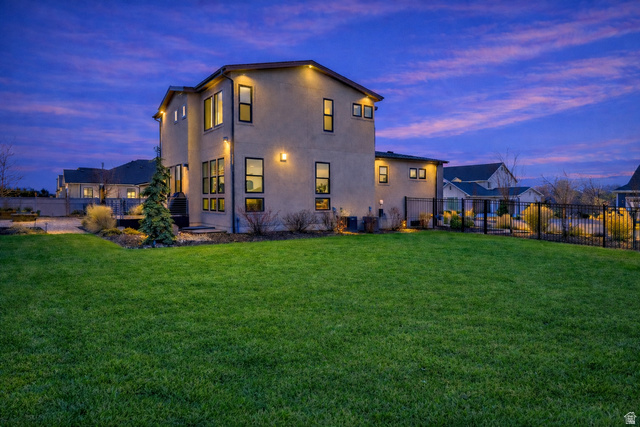 11617 South Wildrye Field Way Draper, UT 84020 - Photo 44 of 53 Back of house at dusk with a fenced backyard and large deck and entertaining area