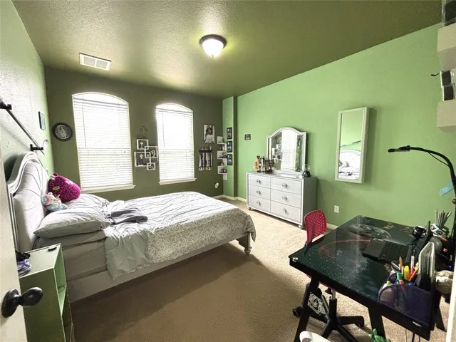 a bed sitting in a bedroom next to a window