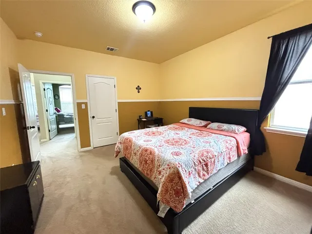 a bedroom with a bed and a couch