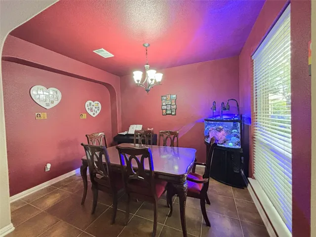 a view of a dining room with furniture and chandelier
