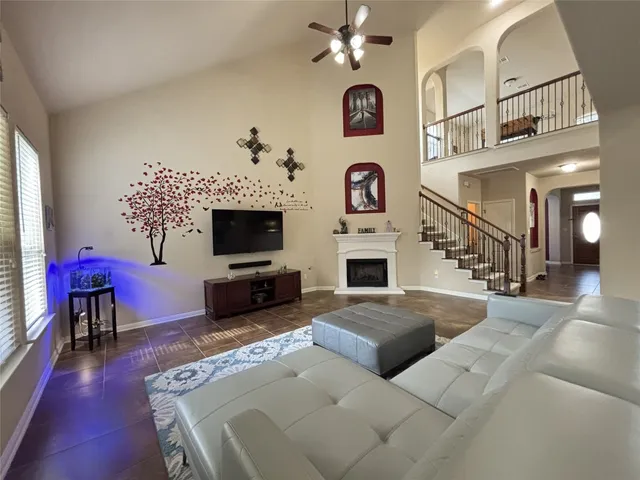 a living room with furniture a flat screen tv and a fireplace