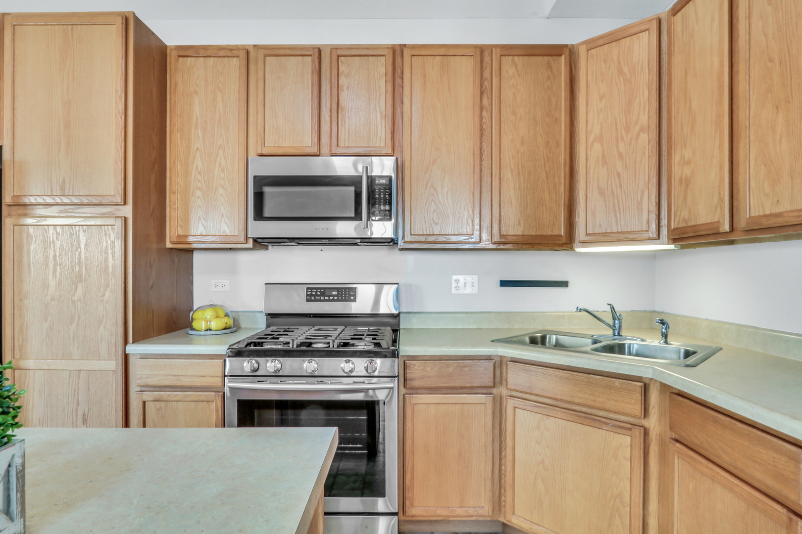 1491 Sedgewood Court Round Lake, IL 60073 - Photo 11 of 31 a kitchen with granite countertop a stove a sink and a white cabinets