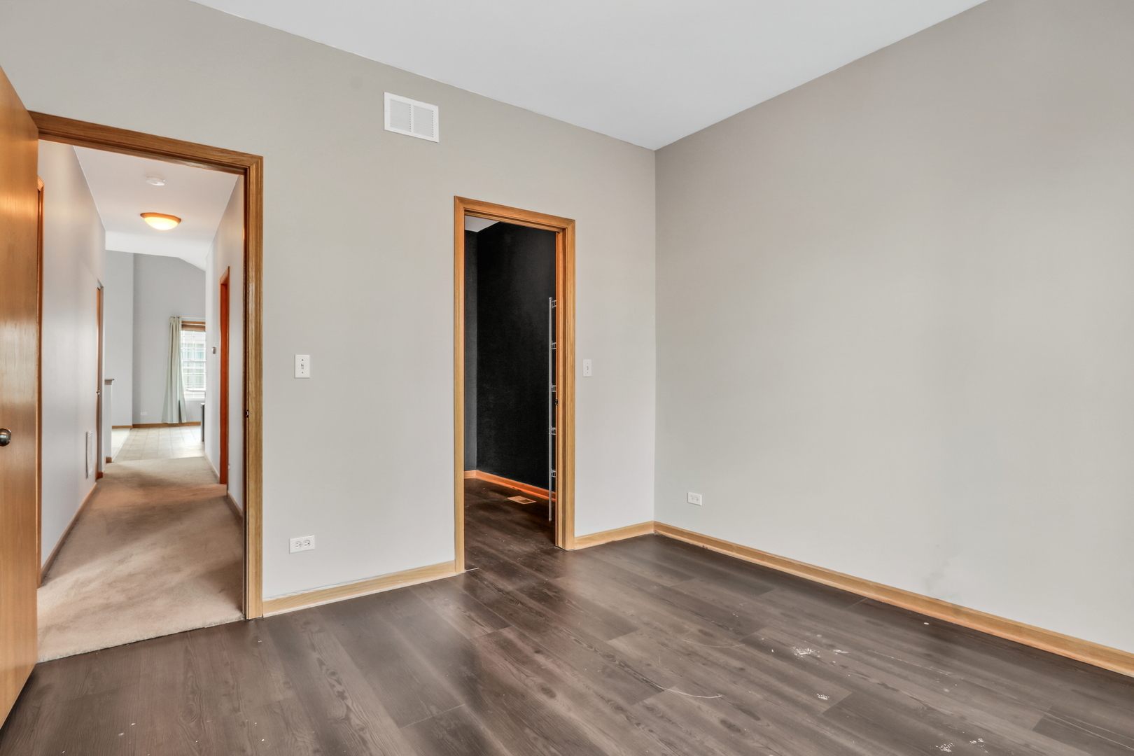1491 Sedgewood Court Round Lake, IL 60073 - Photo 18 of 31 an empty room with wooden floor and a hallway